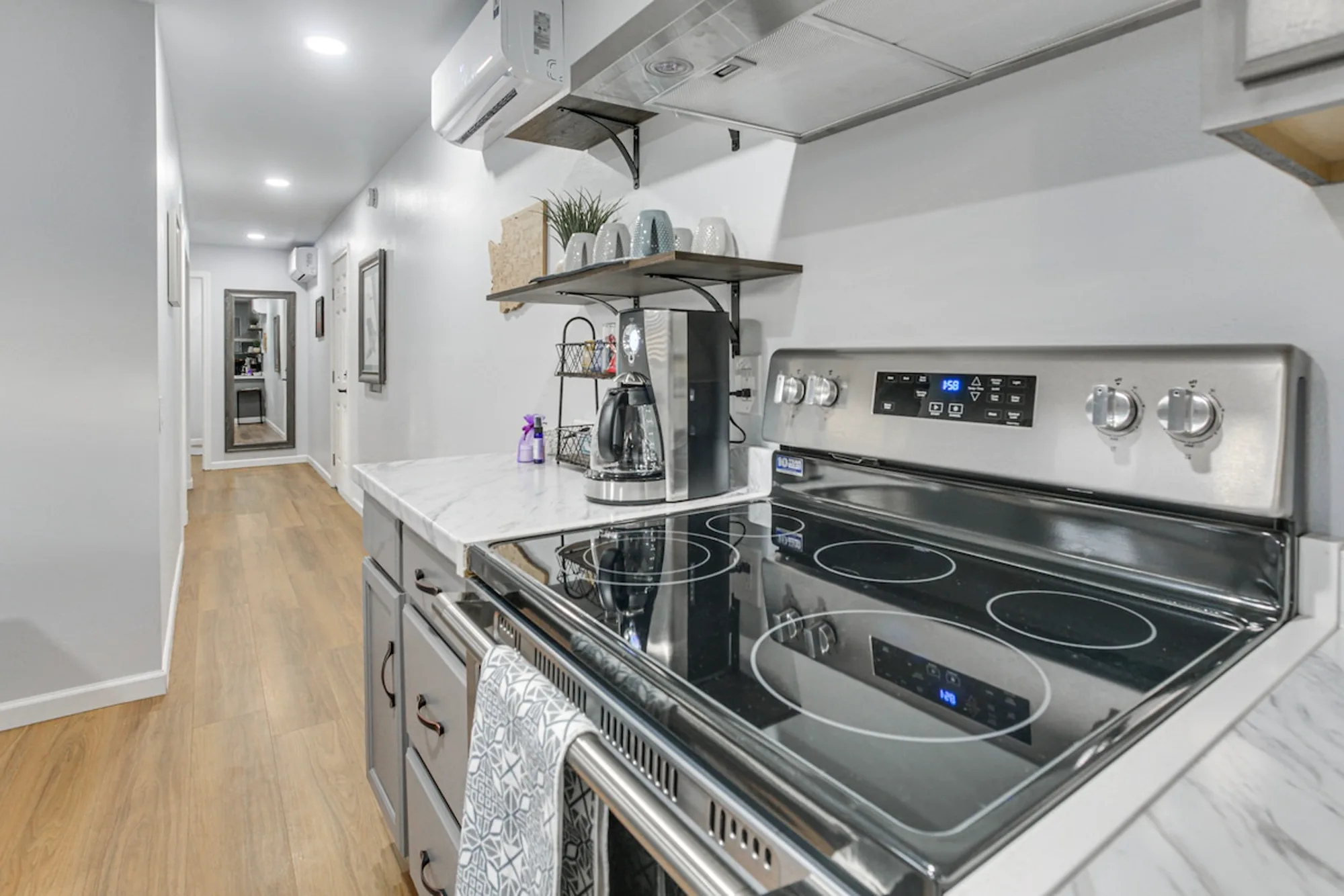 Remodeled kitchen in a Vista Verde property — new range, hood, custom shelving, and counters